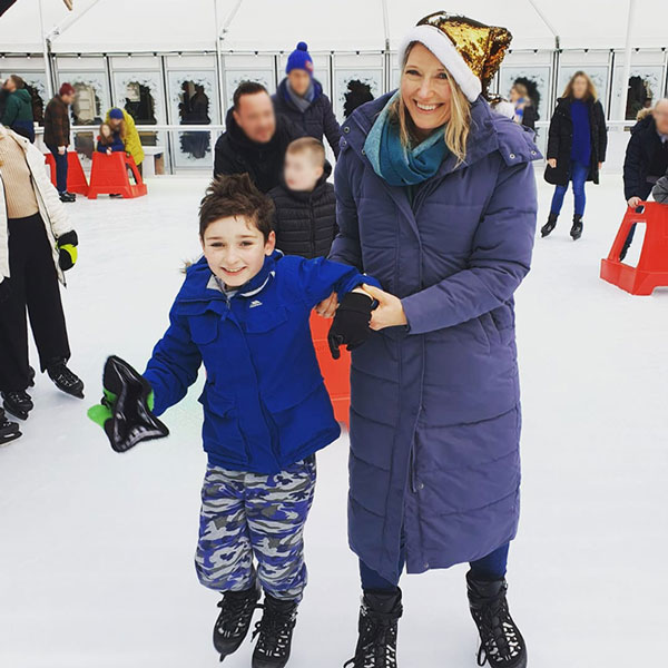 Mary Watkins ice skating with her son in a festive hat